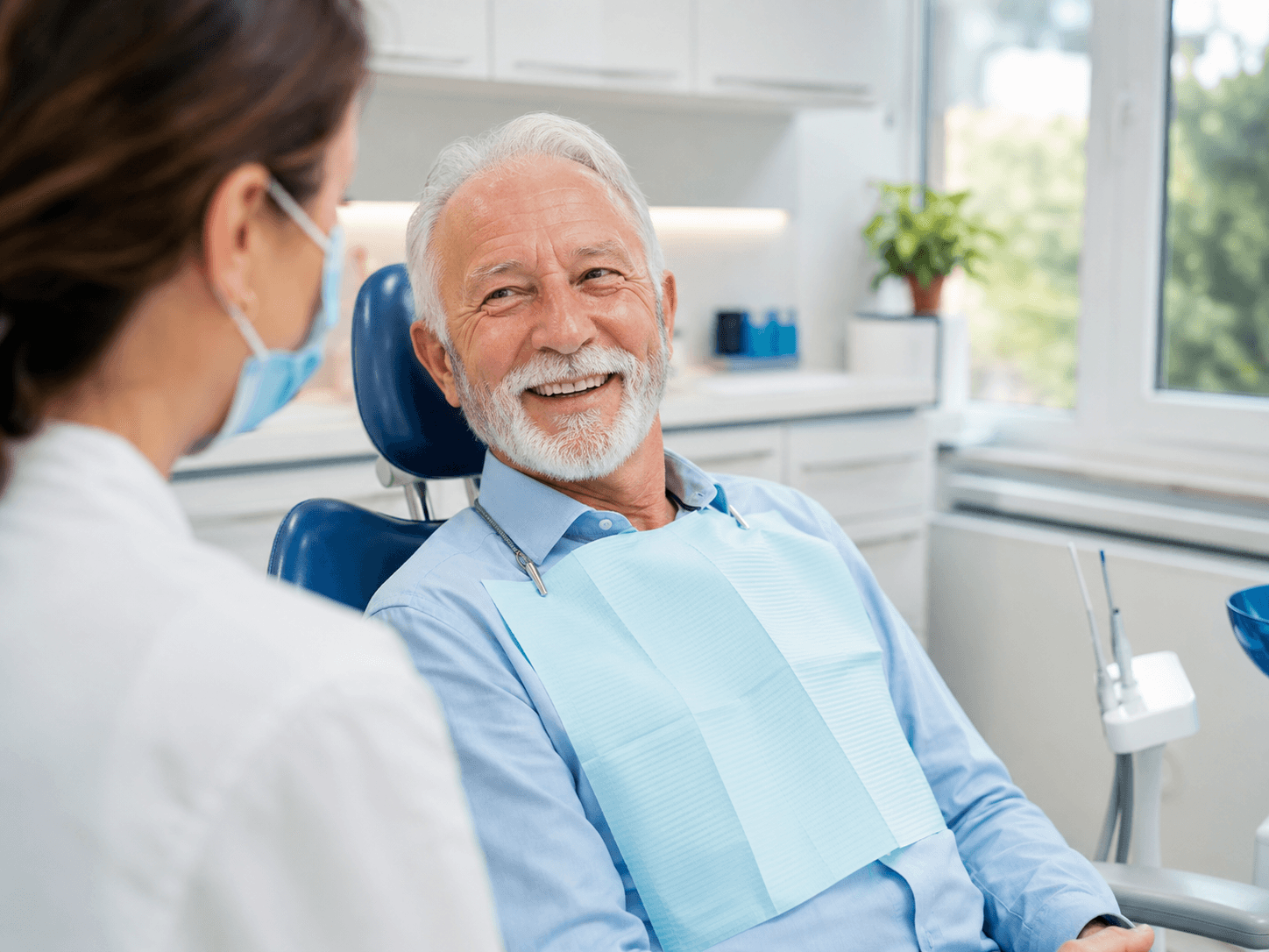 An older adult smiling during a routine dental checkup