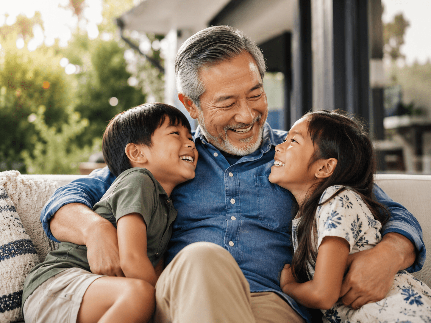 A grandfather laughing with his grandchildren, staying connected and engaged